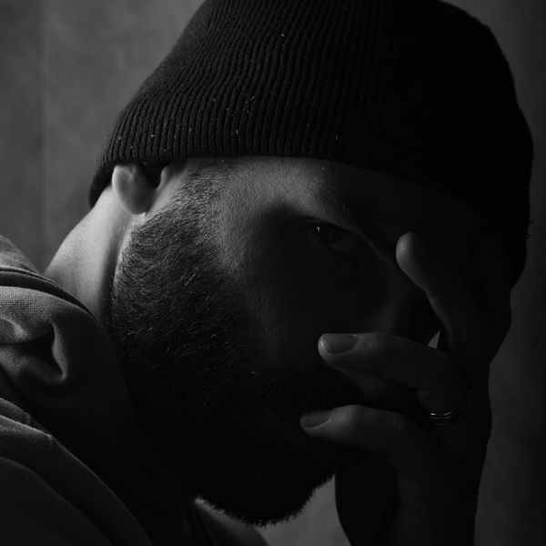Silhouette of a man in a focused pose against a dark background.